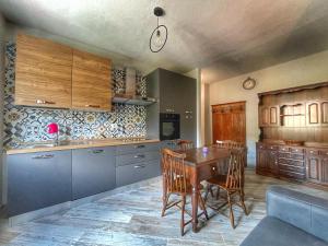 eine Küche mit einem Tisch und Stühlen im Zimmer in der Unterkunft Il nido dello Chaberton in Cesana Torinese