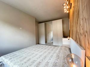 a small bedroom with a bed and a table at Il nido dello Chaberton in Cesana Torinese