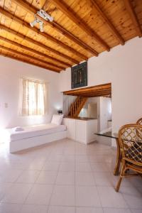 Mykonos in White في مدينة ميكونوس: غرفة معيشة مع سرير ونافذة