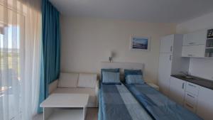 a small bedroom with a bed and a couch at Camera de închiriat Blaxy Premium Resort in Olimp