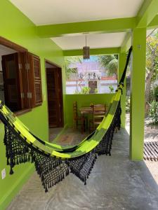 a hammock on the front porch of a house at Pousada Lotus in Prea