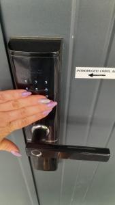 a woman holding a door knob with her hand at Casa Larisa - Wolves Apartment in Sinaia