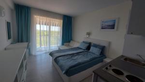 a small bedroom with a bed and a window at Camera de închiriat Blaxy Premium Resort in Olimp