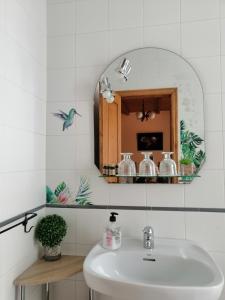 a bathroom with a sink and a mirror at Casa Licerio in Samos