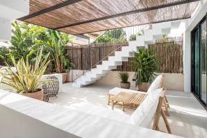 an outdoor patio with a bench and potted plants at Can Micalet in La Savina