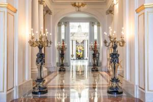 a hallway with chandeliers and candles in a building at Hotel Le Negresco in Nice