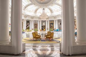a room with a table and chairs in a building at Hotel Le Negresco in Nice