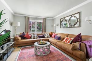 a living room with a couch and a table at Poplar Cottage, Budleigh Salterton in Budleigh Salterton