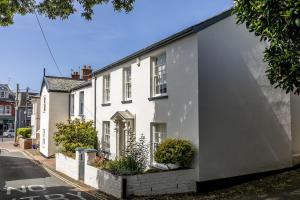 a white house on the side of a street at Poplar Cottage, Budleigh Salterton in Budleigh Salterton