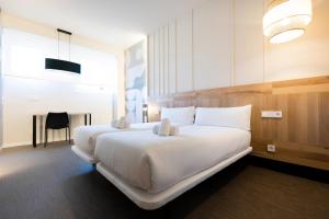 Posteľ alebo postele v izbe v ubytovaní URBAIA ROOMS