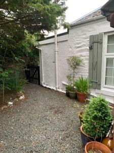 a house with potted plants in front of it at Cedarbank’s - 'Little Art House' in Kirn