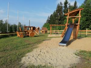 a park with a playground with a slide and a slideintend at VogtlandCAMPING in Markneukirchen