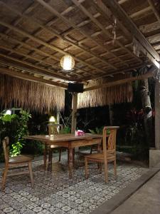 a wooden table and chairs under a pavilion at Luxury Villa Ada Padi Ubud one bed room in Ubud