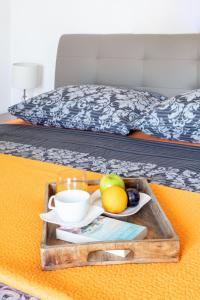 a tray of fruit on a table in a bed at Apartments Dobrila in Hvar