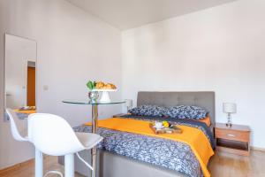 a bedroom with a bed with a tray of fruit on it at Apartments Dobrila in Hvar