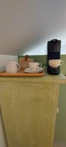 a counter with two cups and a coffee maker on it at Cosy Corner in Jalhay