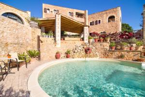 a house with a swimming pool in a yard at Samonas - Red villa Fliskouni in Chania