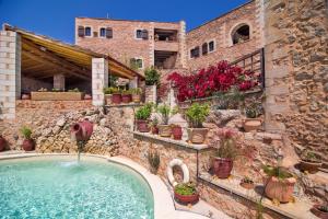 a house with a swimming pool and plants at Samonas - Red villa Fliskouni in Chania