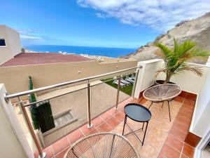 a balcony with chairs and a view of the ocean at Luxury Villa Masca private heated pool in Adeje