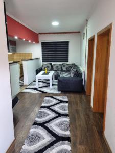 a living room with a couch and a table at Apartman Vany in Tuzla