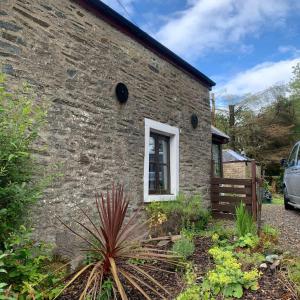 a brick building with a window on the side of it at Yewtree Cottage - 'The Art House' and Garden in Hunters Quay