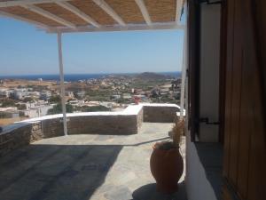 a balcony with a view of the ocean from a house at Cycladic House in Vári