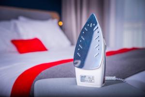 a blue and white iron sitting on top of a bed at Holiday Inn Express - Glasgow - City Ctr Theatreland, an IHG Hotel in Glasgow