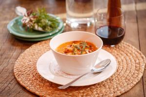 a bowl of soup on a plate on a table at Chalten Camp - Glamping with a view in El Chalten