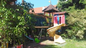 a playground with a slide in a garden at Patak28 Apartmanok in Sopron