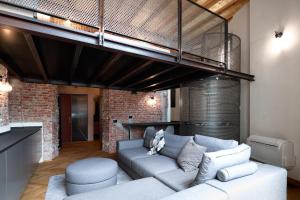 a living room with a couch and a loft at LANCETTI Stylish Loft - hosted by Sweetstay in Milan