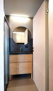 a bathroom with a sink and a mirror at LANCETTI Stylish Loft - hosted by Sweetstay in Milan