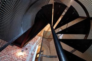 a spiral staircase with a black umbrella at LANCETTI Stylish Loft - hosted by Sweetstay in Milan