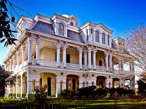 a large white house with white columns at Dansereau House in Thibodaux