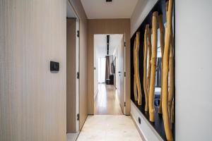 a hallway with surfboards hanging on a wall at Blanche Cliff Apartments in Sveti Stefan