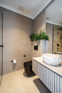 a bedroom with a bed and a plant on the wall at Blanche Cliff Apartments in Sveti Stefan