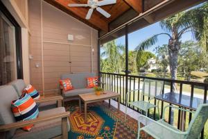 a screened in porch with a couch and a table at COQUINA BEACH 3G in Sanibel