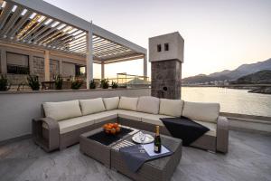 a living room with a couch and a table at Blanche Cliff Apartments in Sveti Stefan