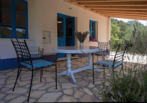 a white table and chairs on a patio at Studio apartman ROZA in Ston