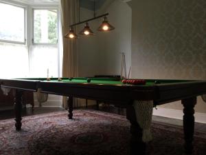 a room with a pool table in a room with a window at The Old School House in Durham