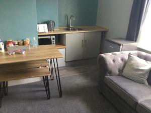 a living room with a couch and a table at The Old School House in Durham