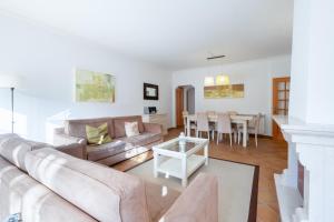 a living room with a couch and a table at Fantastic T3 Sebastião in Casal da Lagoa Seca