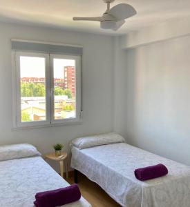 1 Schlafzimmer mit 2 Betten und einem Fenster in der Unterkunft 2 baños! Piso grande 100 m2 y Garaje gratis in Madrid
