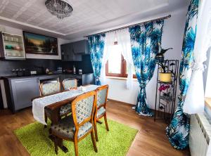 a kitchen and dining room with a table and chairs at Szostak Apartament in Bańska Niżna