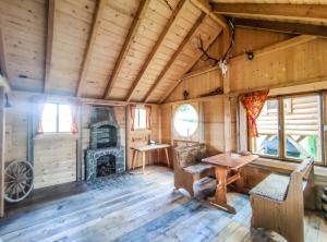 a wooden room with a table and a fireplace in a cabin at Szostak Apartament in Bańska Niżna