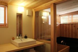 a bathroom with a white sink and a shower at Chiiori in Miyoshi