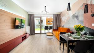 Televízia a/alebo spoločenská miestnosť v ubytovaní Apartamenty Good Time- Stone Hill II