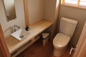 a small bathroom with a toilet and a sink at Chiiori in Miyoshi