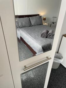 a mirror reflection of a bed in a bedroom at Ancaster Apartments in Brumby