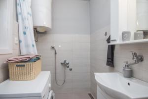 a white bathroom with a shower and a sink at Kuća za odmor DM in Bajina Bašta +13 photos