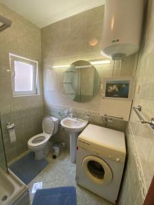 a bathroom with a toilet sink and a mirror at Villa Svetlana in Prčanj